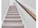 Carpeted staircase with a wooden handrail at 310 Sandridgebury Dr. # 40, Little River, SC 29566