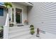 Welcoming front entrance with steps, decorative plants, and a charming door at 4343 Baldwin Ave. # 4343, Little River, SC 29566