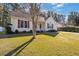 House exterior with a tree in the front yard, red shutters and a partial view of a driveway at 4490 Bradford Circle, Myrtle Beach, SC 29588