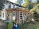 House exterior with additional structure and overgrown landscaping at 502 Helena St., Georgetown, SC 29440