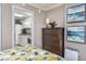 Bedroom with dresser, small kitchen, and coastal decor at 6900 N Ocean Blvd. # 1540, Myrtle Beach, SC 29572