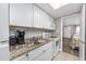 White kitchen with granite countertops and appliances at 6900 N Ocean Blvd. # 1540, Myrtle Beach, SC 29572