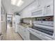 Full kitchen with white cabinets, granite, and appliances at 6900 N Ocean Blvd. # 1540, Myrtle Beach, SC 29572