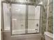 Clean bathroom with a tub/shower combination and tropical wallpaper at 8500 Margate Circle # 209, Myrtle Beach, SC 29572