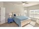 Bright bedroom with a queen bed, large windows, and an ensuite bathroom at 208 Angel Wing Dr., Myrtle Beach, SC 29588