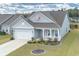 Gray siding house with white accents, landscaping, and a two-car garage at 208 Angel Wing Dr., Myrtle Beach, SC 29588