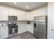 Modern kitchen with white cabinets and stainless steel appliances at 208 Angel Wing Dr., Myrtle Beach, SC 29588