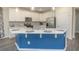 Modern kitchen with white cabinets, a blue island, and stainless steel appliances at 208 Angel Wing Dr., Myrtle Beach, SC 29588