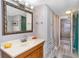 Clean bathroom with wood vanity and a large mirror at 6001-1774 S Kings Hwy., Myrtle Beach, SC 29575