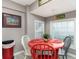 Small dining area with red table and colorful chairs at 6001-1774 S Kings Hwy., Myrtle Beach, SC 29575