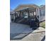 Tan house with a porch, dark brown steps, and attached garage at 6001-1774 S Kings Hwy., Myrtle Beach, SC 29575