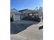 Tan house with a porch, dark brown steps, and attached garage at 6001-1774 S Kings Hwy., Myrtle Beach, SC 29575