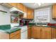 Efficient kitchen with wood cabinets and green countertops at 6001-1774 S Kings Hwy., Myrtle Beach, SC 29575