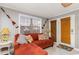Living room with orange sectional couch and access to outside at 6001-1774 S Kings Hwy., Myrtle Beach, SC 29575