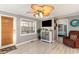 Living room with orange couch, TV, and ceiling fan at 6001-1774 S Kings Hwy., Myrtle Beach, SC 29575