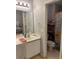 Bathroom with single vanity, shower/tub combo, and shelving at 706 Wintercreeper Dr., Longs, SC 29568