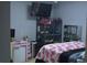 Bright bedroom with a queen bed and a large TV at 706 Wintercreeper Dr., Longs, SC 29568