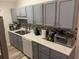 Kitchen boasts gray cabinets, mosaic backsplash, and modern appliances at 706 Wintercreeper Dr., Longs, SC 29568