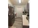 Gray kitchen cabinets, white countertops, and stainless steel appliances at 706 Wintercreeper Dr., Longs, SC 29568