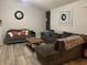 Spacious living room with gray sectional sofa and wood-look floors at 706 Wintercreeper Dr., Longs, SC 29568