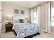 Cozy bedroom with a queen-size bed, neutral decor, and ample natural light at 7071 Denim Loop, Myrtle Beach, SC 29575