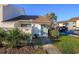 Ground level view of condo building exterior, walkway, and landscaping at 1000 11Th Ave. N # 126, North Myrtle Beach, SC 29582