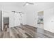 Main bedroom with sliding barn door, access to bathroom and additional room at 140 Wimbledon Way # 140, Murrells Inlet, SC 29576