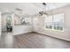 Bright dining room with hardwood floors, a kitchen view, and a chandelier at 140 Wimbledon Way # 140, Murrells Inlet, SC 29576