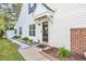 Front entrance of a townhome featuring a brick walkway and landscaping at 140 Wimbledon Way # 140, Murrells Inlet, SC 29576
