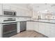 Modern kitchen with stainless steel appliances and white cabinets at 140 Wimbledon Way # 140, Murrells Inlet, SC 29576