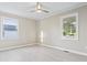 Spacious bedroom with neutral decor, two windows and vinyl plank flooring at 209 Centenary Ave., Marion, SC 29571