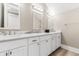 Double vanity bathroom with marble countertop and white cabinets at 219 South Seaside Dr., Surfside Beach, SC 29575