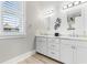 Bright bathroom featuring double sinks, white cabinets, and a modern design at 219 South Seaside Dr., Surfside Beach, SC 29575