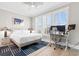 Spacious bedroom with a queen-size bed, a workspace, and plenty of natural light at 219 South Seaside Dr., Surfside Beach, SC 29575