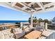 Relaxing ocean view deck with seating and a wooden table at 219 South Seaside Dr., Surfside Beach, SC 29575