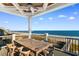 Covered deck with outdoor dining set, overlooking the beach at 219 South Seaside Dr., Surfside Beach, SC 29575