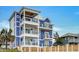 Stunning three-story beach home with multiple balconies and white accents at 219 South Seaside Dr., Surfside Beach, SC 29575