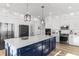 Modern kitchen with blue island and white cabinets at 219 South Seaside Dr., Surfside Beach, SC 29575