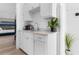Small galley kitchenette with white cabinets and marble countertop at 219 South Seaside Dr., Surfside Beach, SC 29575