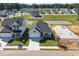 Aerial view of homes, a pond, and under-construction properties at 2412 Campton Loop, Conway, SC 29527