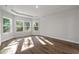 Well-lit bedroom with wood-look floors and multiple windows at 2412 Campton Loop, Conway, SC 29527