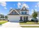 Two-story house with gray siding, white garage door, and stone accents at 2476 Campton Loop, Conway, SC 29527