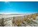 Sandy beach with wooden fence and dune grasses at 2711 S Ocean Blvd. # 1522, North Myrtle Beach, SC 29582