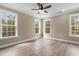Spacious bedroom with hardwood floors and multiple windows at 3329 Hughes Gasque Rd., Aynor, SC 29511