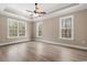 Bright and airy bedroom with wood-look floors and multiple windows at 3329 Hughes Gasque Rd., Aynor, SC 29511