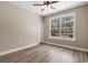 Spacious bedroom with a ceiling fan and large window overlooking wooded area at 3329 Hughes Gasque Rd., Aynor, SC 29511