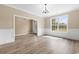 Spacious dining room with hardwood floors, wainscoting, and a view of the entryway at 3329 Hughes Gasque Rd., Aynor, SC 29511