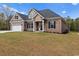 Two-story home with a brick and siding exterior, three-car garage, and spacious yard at 3329 Hughes Gasque Rd., Aynor, SC 29511