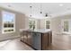 Modern kitchen with island, stainless steel appliances, and white quartz countertops at 3329 Hughes Gasque Rd., Aynor, SC 29511