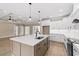 Open kitchen showcasing a large island, white cabinets, and stainless steel appliances at 3329 Hughes Gasque Rd., Aynor, SC 29511